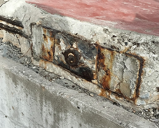 Corroded post tension strand end exposed at the slab edge during repair work