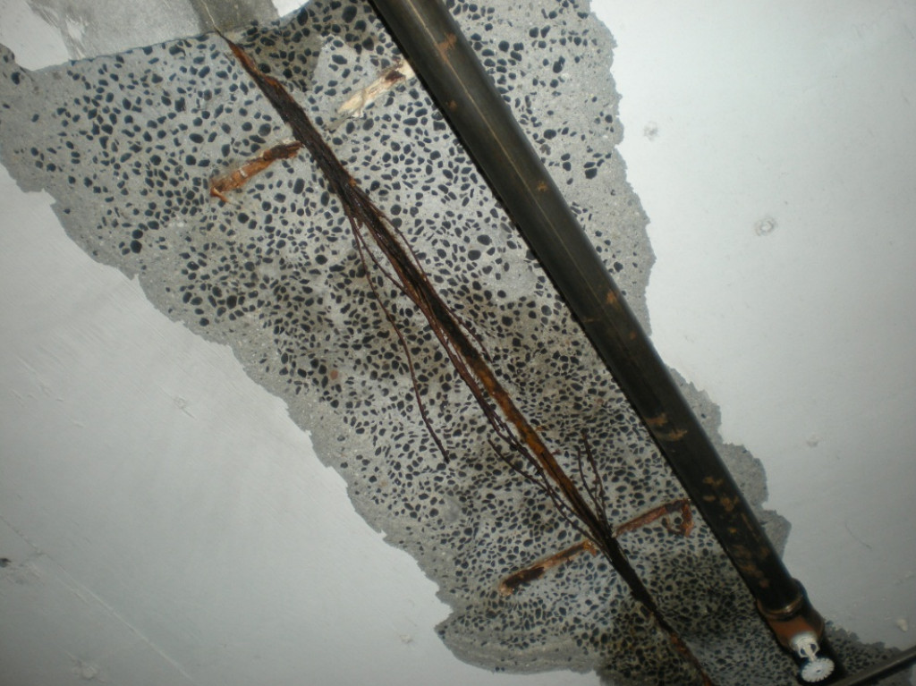 Severely corroded post tension slab tendon wires exposed after moisture infiltration near a leaking pipe